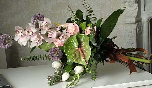 Wedding gift flowers arrangement made of  cymbidium orchids, allium, anthurium, roses and tulips
